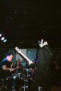 a group of people playing music in a dark room