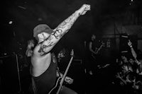 a black and white photo of a man at a concert