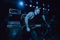 a group of people playing guitar on stage