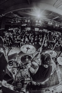 a black and white photo of a band playing in front of a crowd