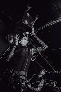 a black and white photo of a man playing a guitar