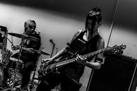 a black and white photo of a group of people playing music