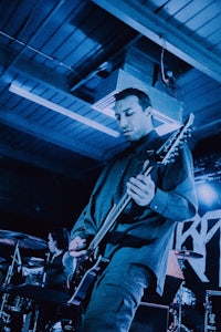 a man playing a guitar at a concert