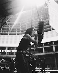 a black and white photo of a man singing into a microphone